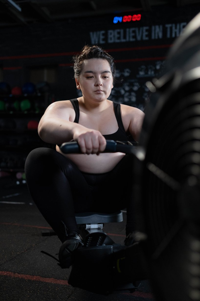 Woman in Black Sports Bra and Black Leggings Exercising